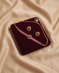 Flat Lay

Ruby Bloom Kundan Choker Set with matching earrings displayed on a maroon velvet jewelry tray.