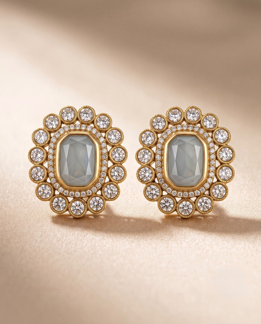Close-up of ivory floral stud earrings with gold-tone finish and sparkling stones.