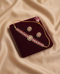 Pink kundan necklace set with matching earrings on burgundy velvet jewellery box