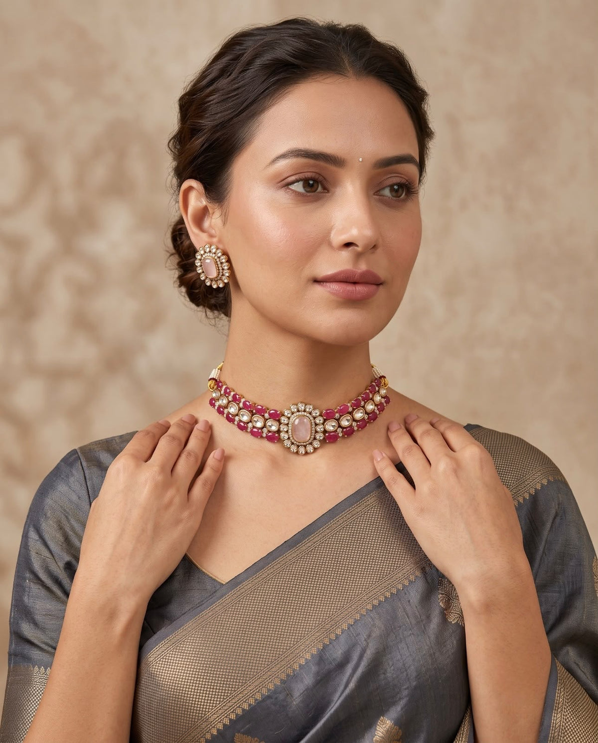Woman wearing pink kundan necklace set with matching earrings