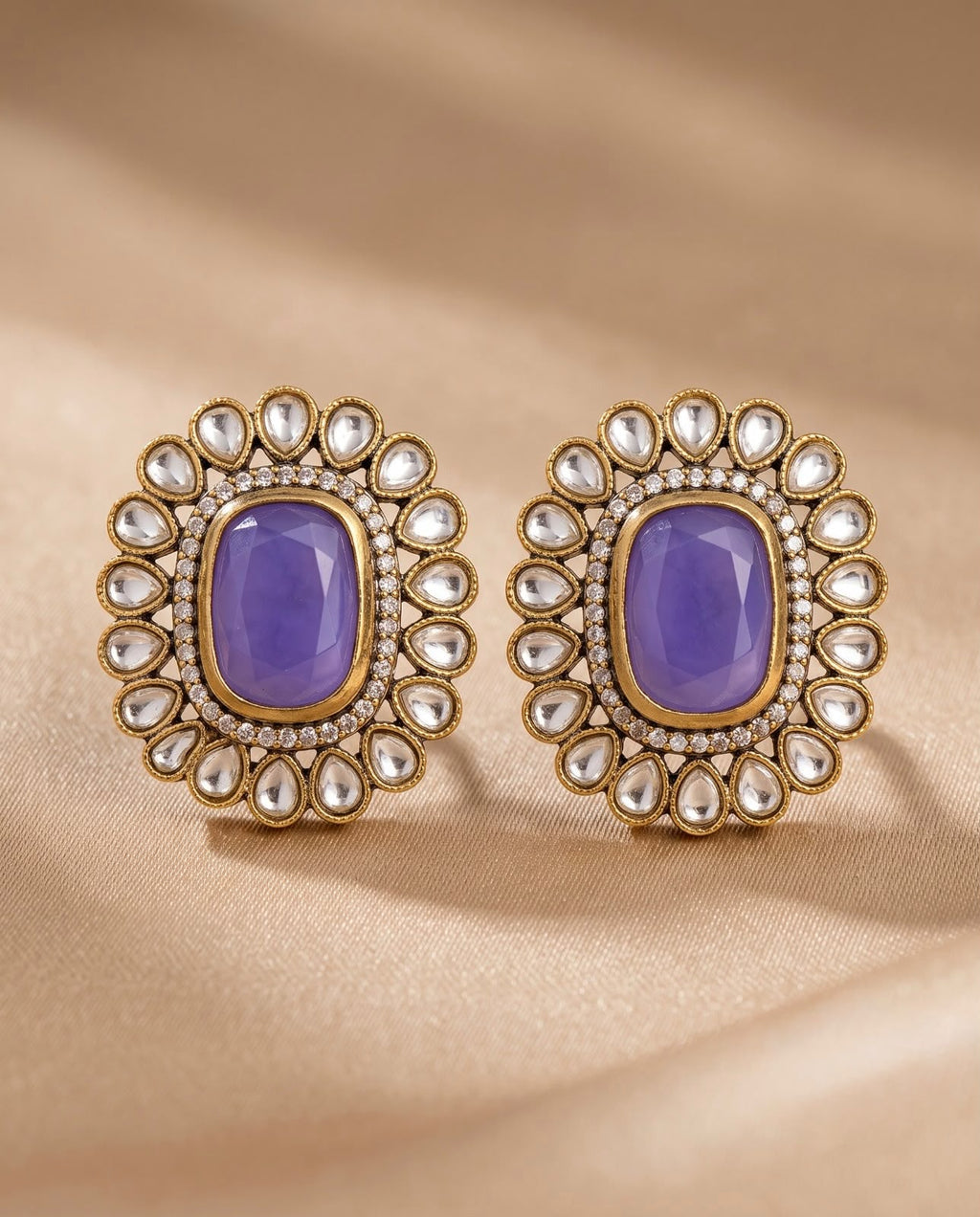 Close-up blue stone kundan style earrings with gold-tone detailing