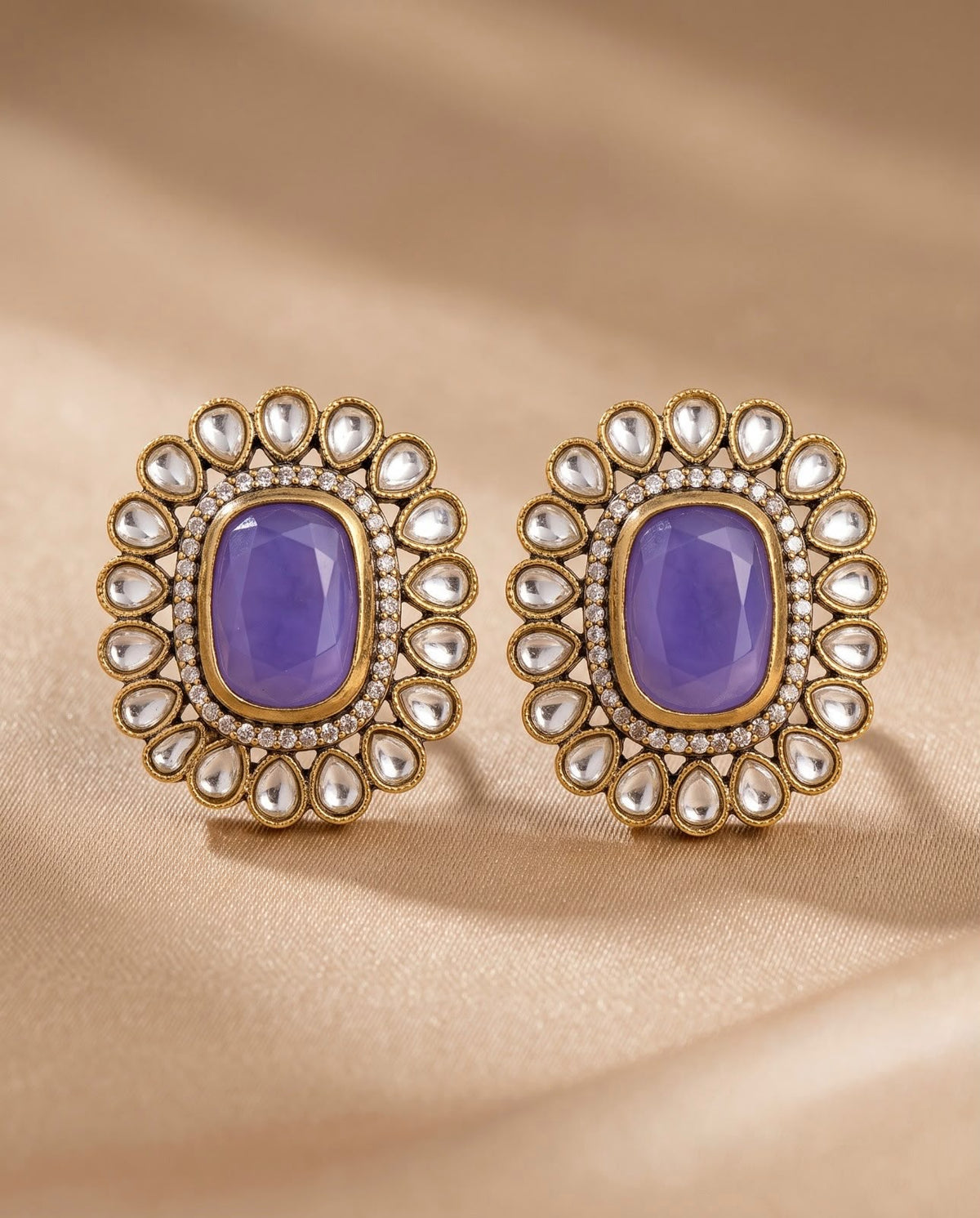 Close-up blue stone kundan style earrings with gold-tone detailing
