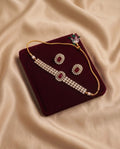 Ruby red kundan necklace set with matching earrings on burgundy velvet