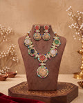 Celestia multicolor statement necklace and earrings displayed on jewelry stand.