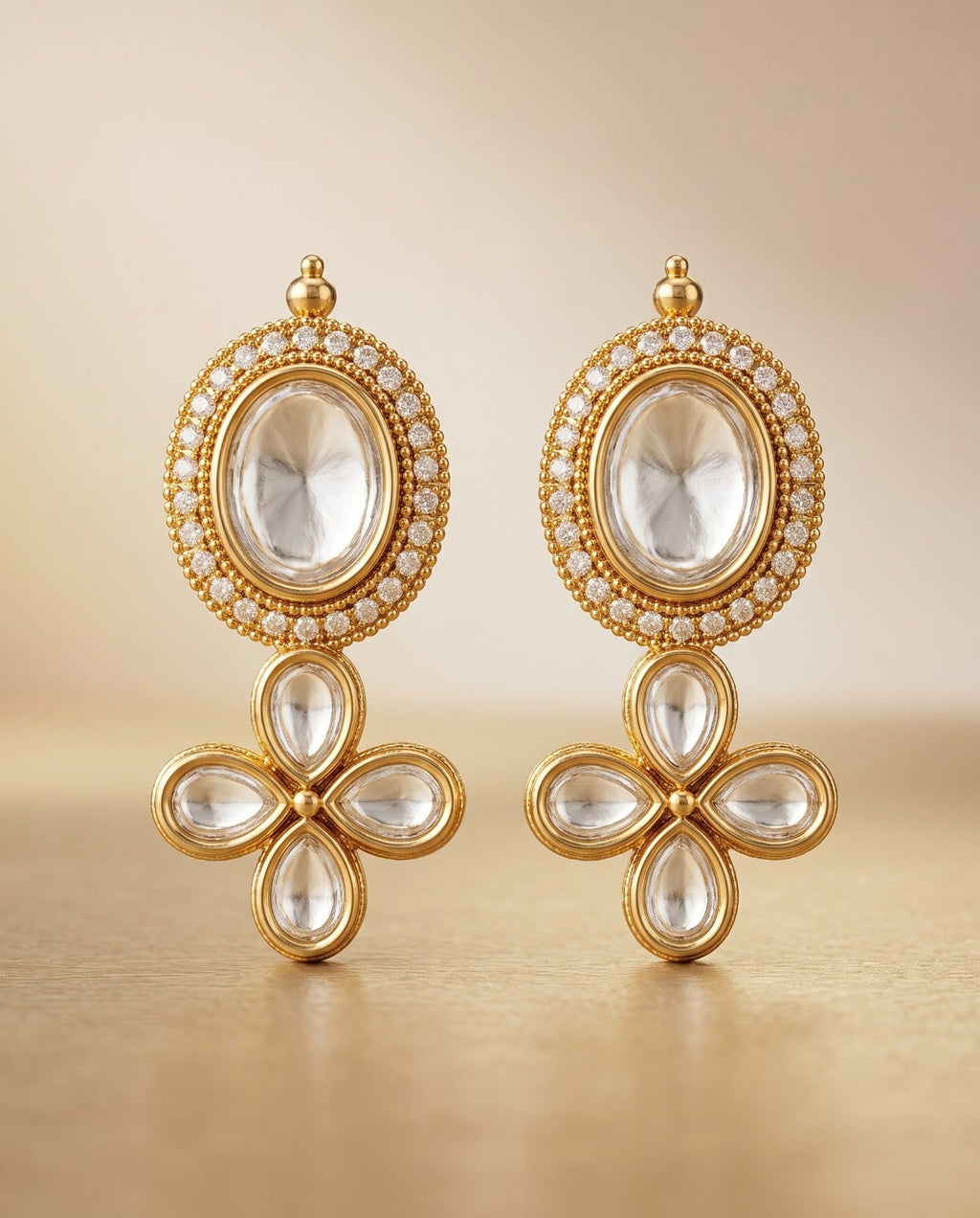 Close-up of gold teardrop earrings with pearl drops