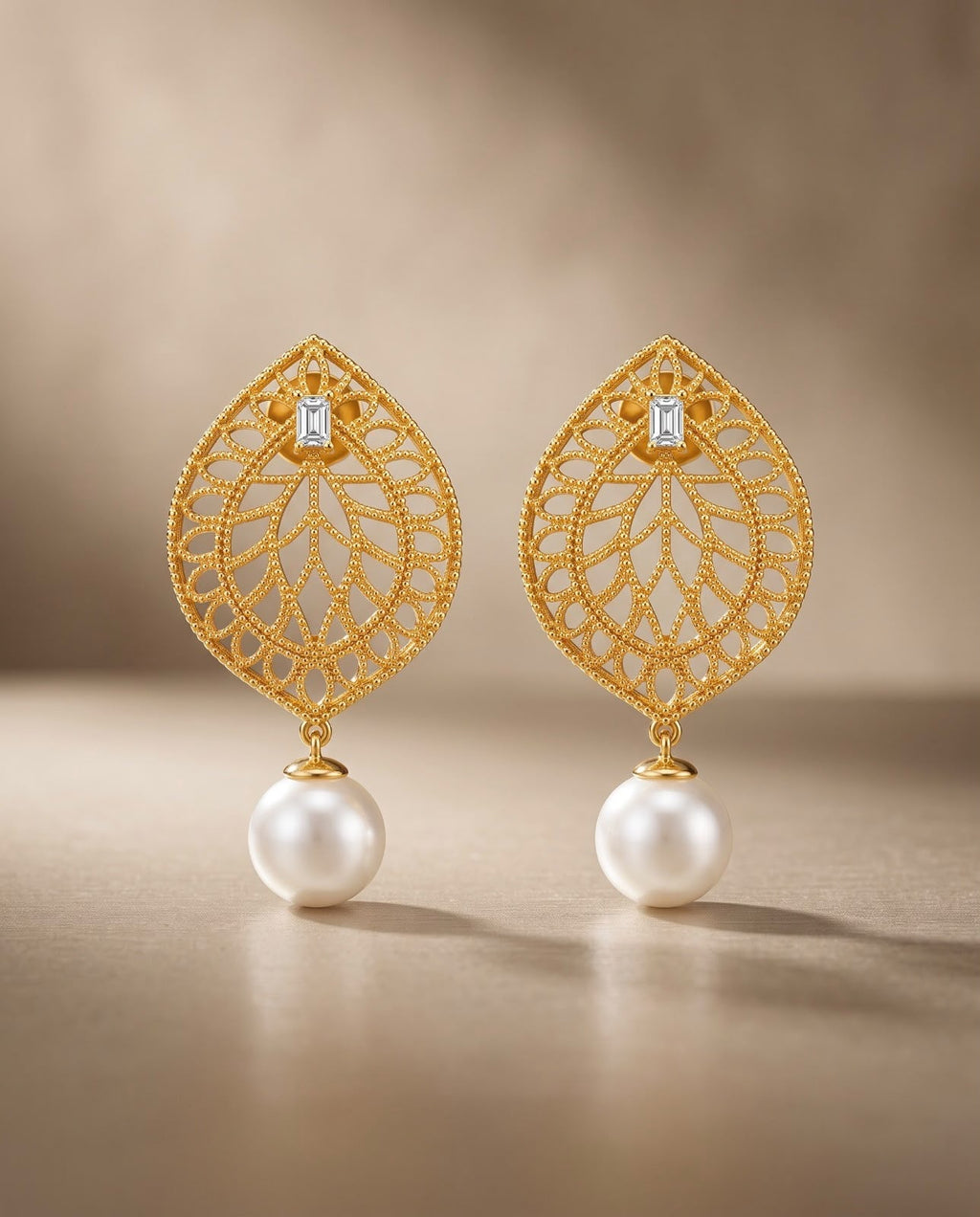 Close-up of gold teardrop earrings with pearl drops