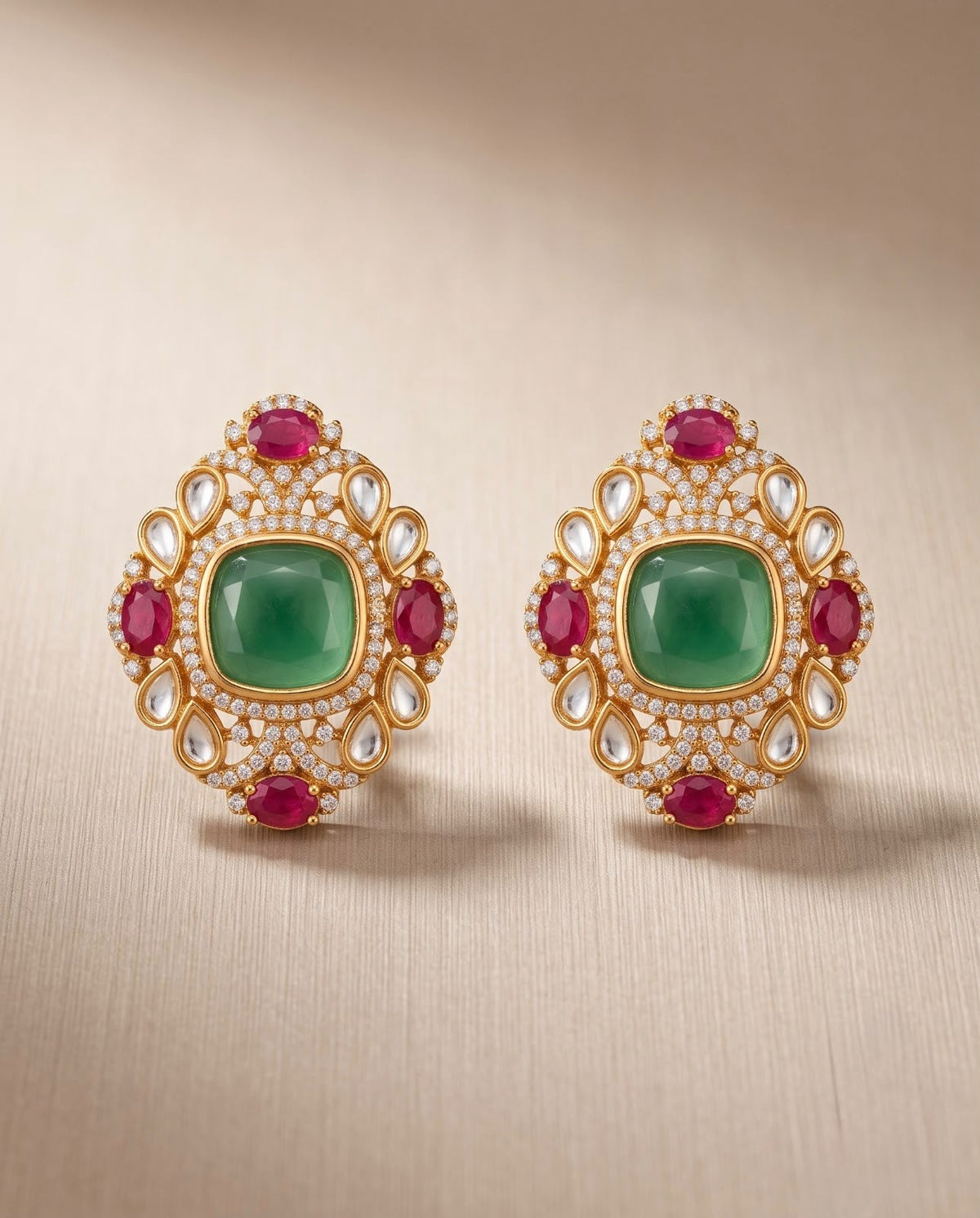 Gold emerald and ruby statement earrings with sparkling stone detailing