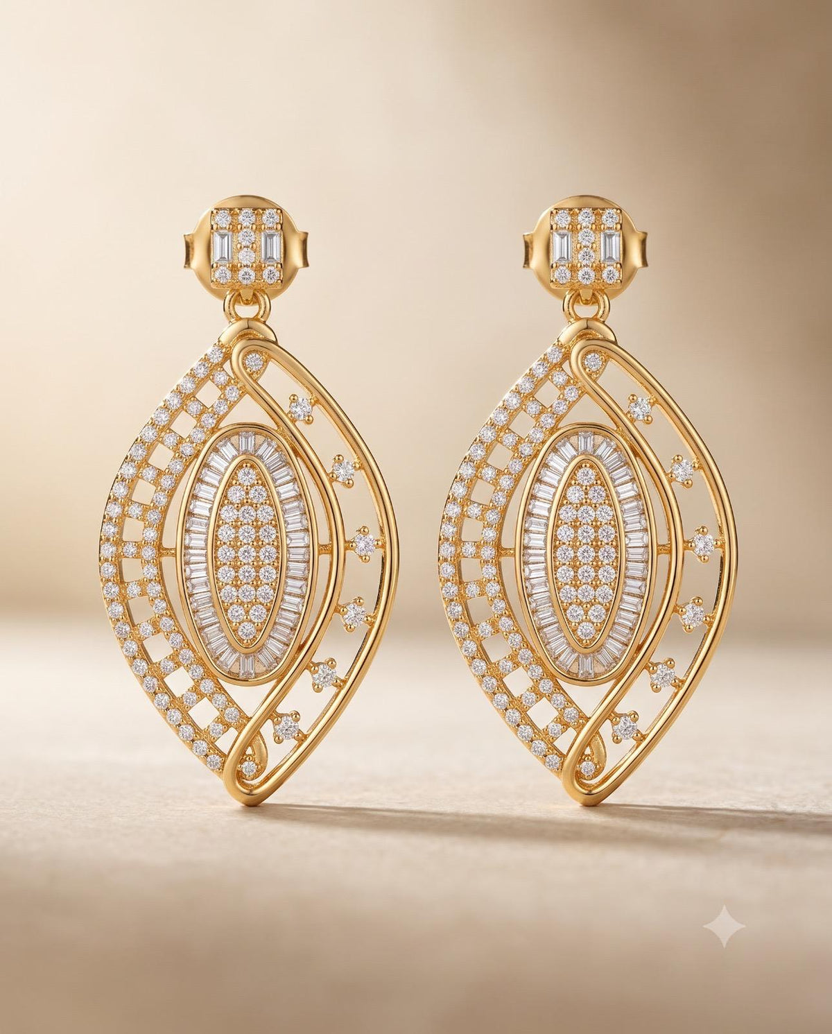 Gold-tone leaf design statement earrings with sparkling stone detailing