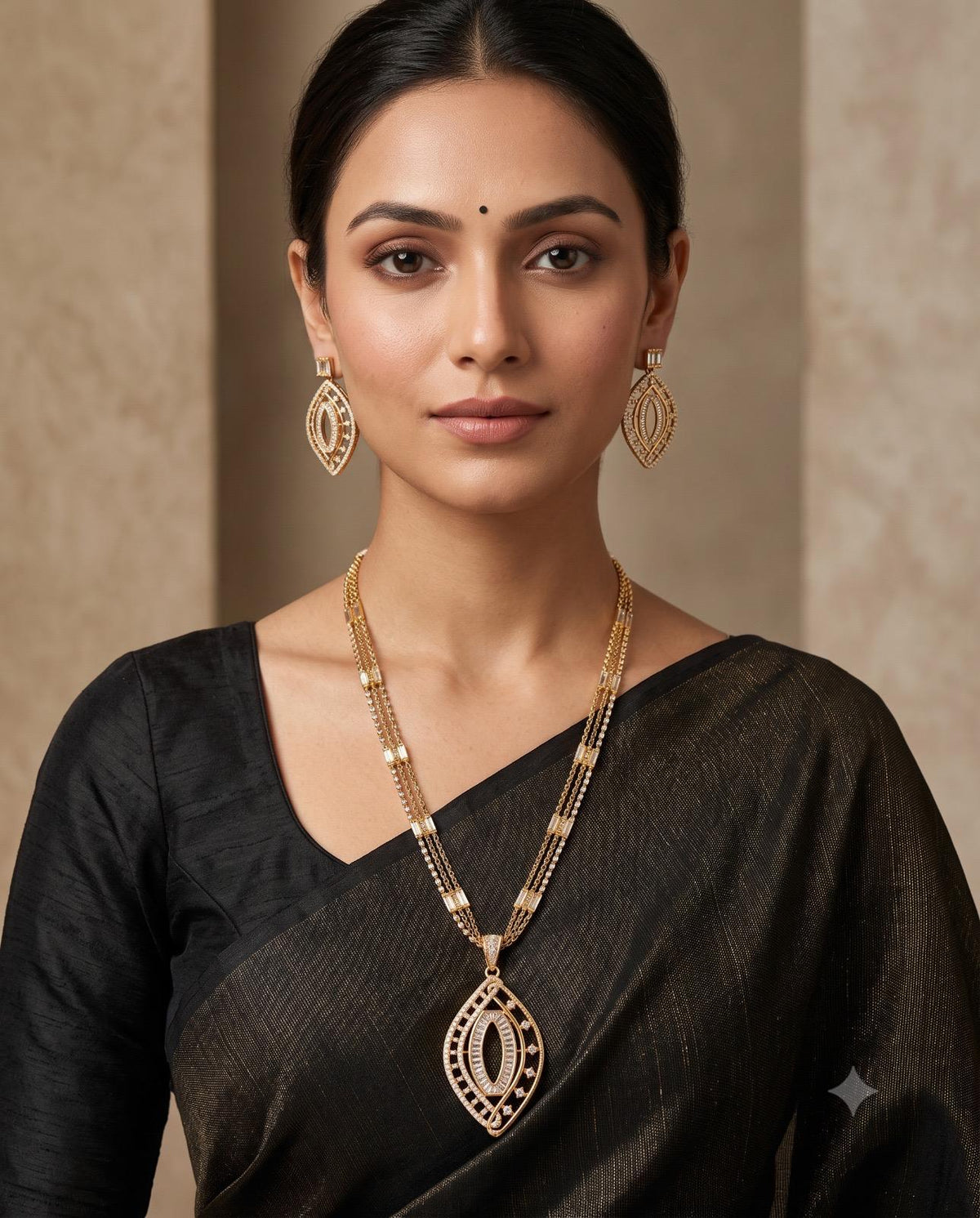 Woman wearing gold-tone leaf motif statement necklace set with black saree