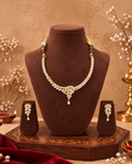 Gold-tone floral necklace set with matching earrings on jewellery bust